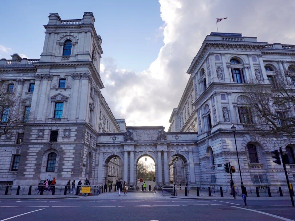 A large white building with a clock tower A large white building with a clock tower