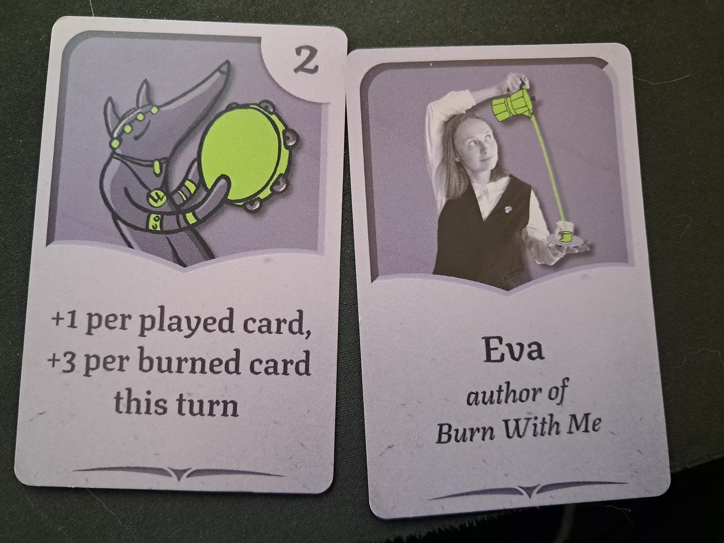 Two business cards from Burn With Me with art directly from the game.