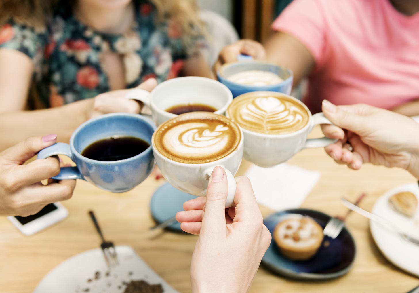 four women enjoying cappuccino