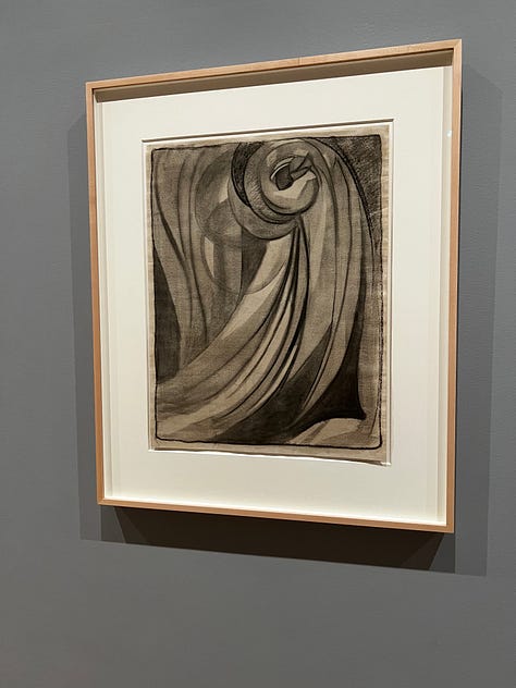 Images from the Georgia O'Keeffe show at the MoMA. Some are works on paper, mostly swirls; others are watercolors of nudes, sunrises, flowers, or rocks.