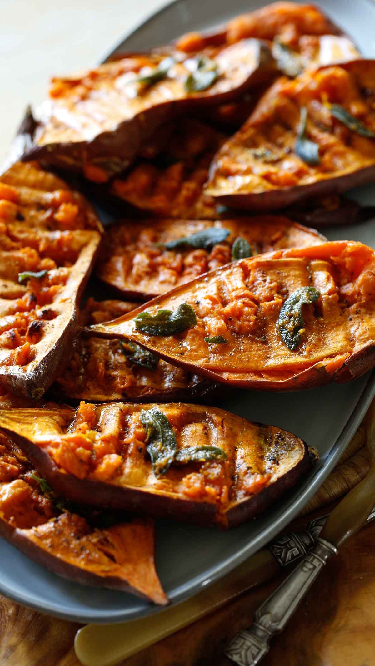 Sweet Potato halves that have been smashed and baked on a platter