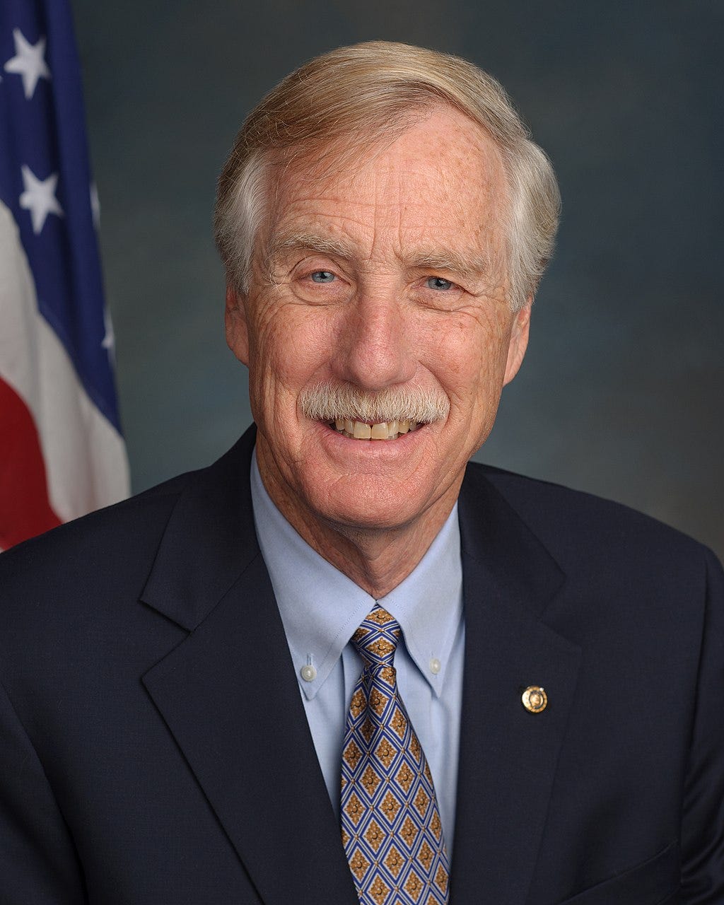 Angus king official portrait; flag in background; white moustache Angus king official portrait; flag in background; white moustache