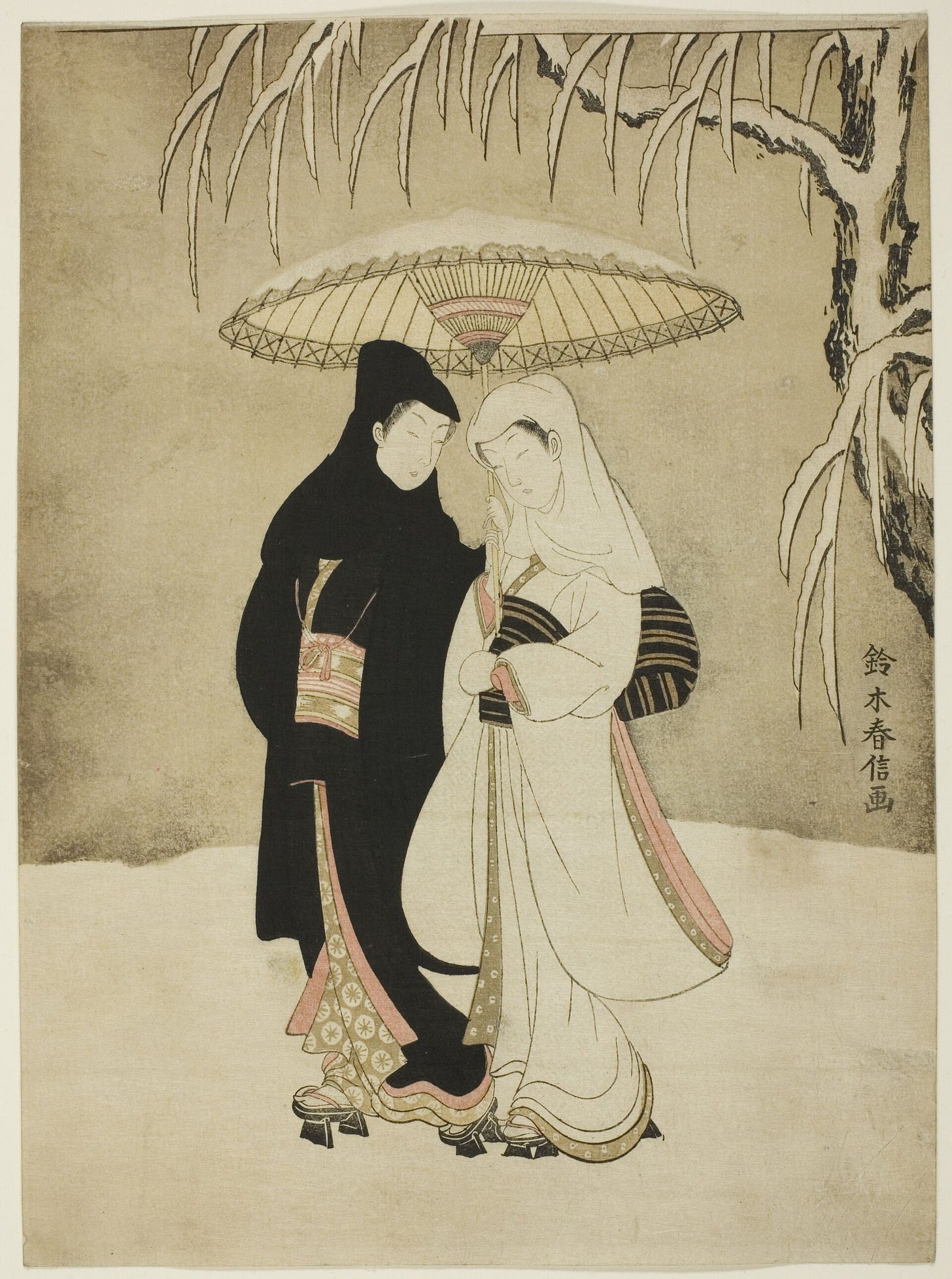 A young man in a black robe and a young woman in a white robe walk close together under one umbrella through falling snow. A young man in a black robe and a young woman in a white robe walk close together under one umbrella through falling snow.