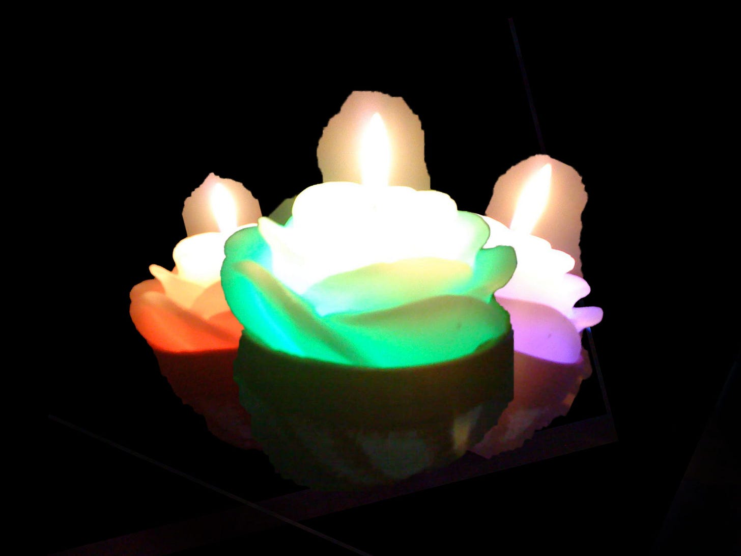Roughly edited image of the three candles overlapping each other in front of a black background.