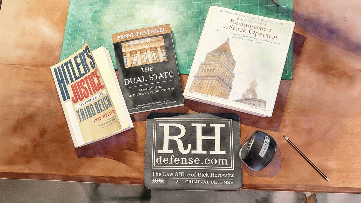 Overhead view of a desk with three books — Hitler’s Justice by Ingo Müller, The Dual State by Ernst Fraenkel, and Reminiscences of a Stock Operator by Edwin Lefèvre — arranged beside a cutting mat, a computer mouse, a pen, and a mousepad labeled “RHDefense.com — The Law Office of Rick Horowitz.”
