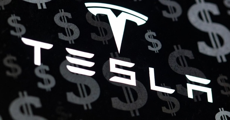 A photograph of a Tesla logo with dollar signs in the background, emphasizing a financial theme. A photograph of a Tesla logo with dollar signs in the background, emphasizing a financial theme.