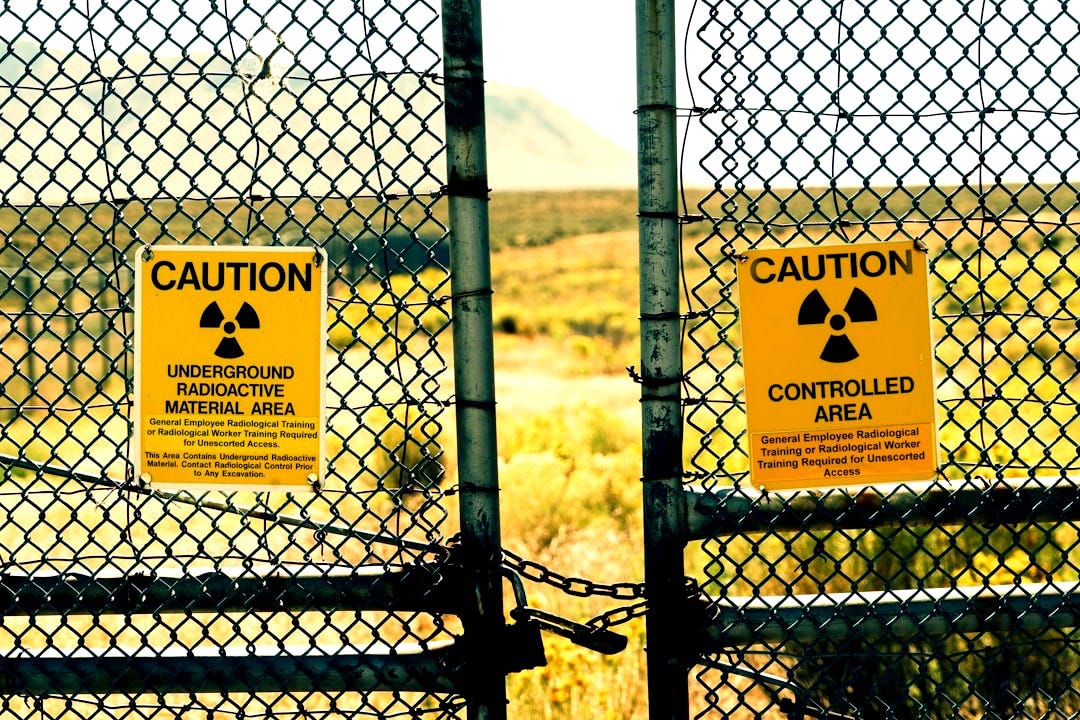 a couple of signs that are on a fence a couple of signs that are on a fence