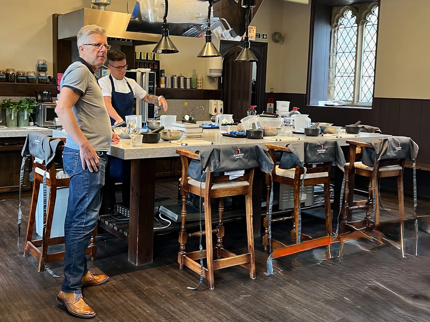 Andy and chef Chris preparing for a course