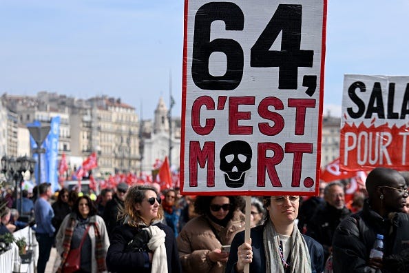 People protesting on the street in France. Sign reads 64 C'est Mort People protesting on the street in France. Sign reads 64 C'est Mort