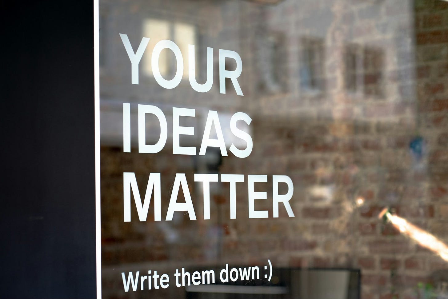 White text on a window reads: YOUR IDEAS MATTER. Write them down :).