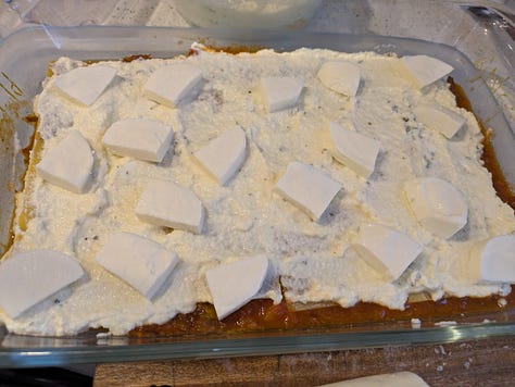 Assembling bottom layers of lasagna.