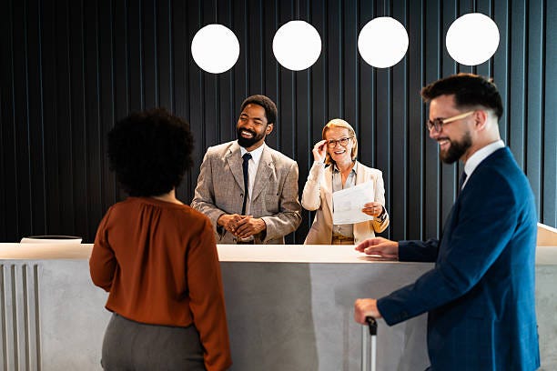 Businesspeople checking in at hotel reception