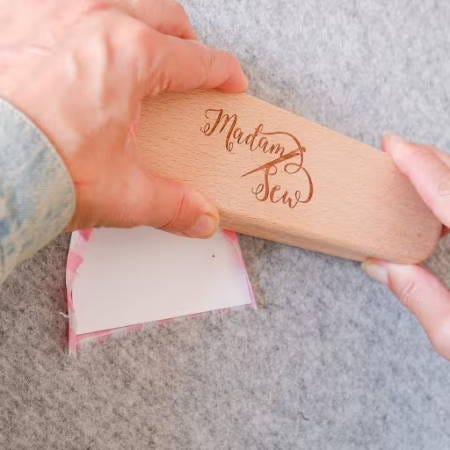 using a clapper to press a curved seam