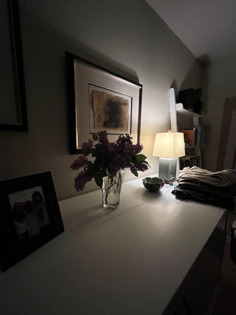 photos of the top of a cabinet with flowers and a lamp