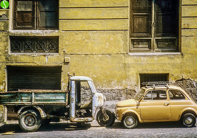1984 photo in Rome of a Moto Guzzi truck and Fiat 500 against an old wall in Rome