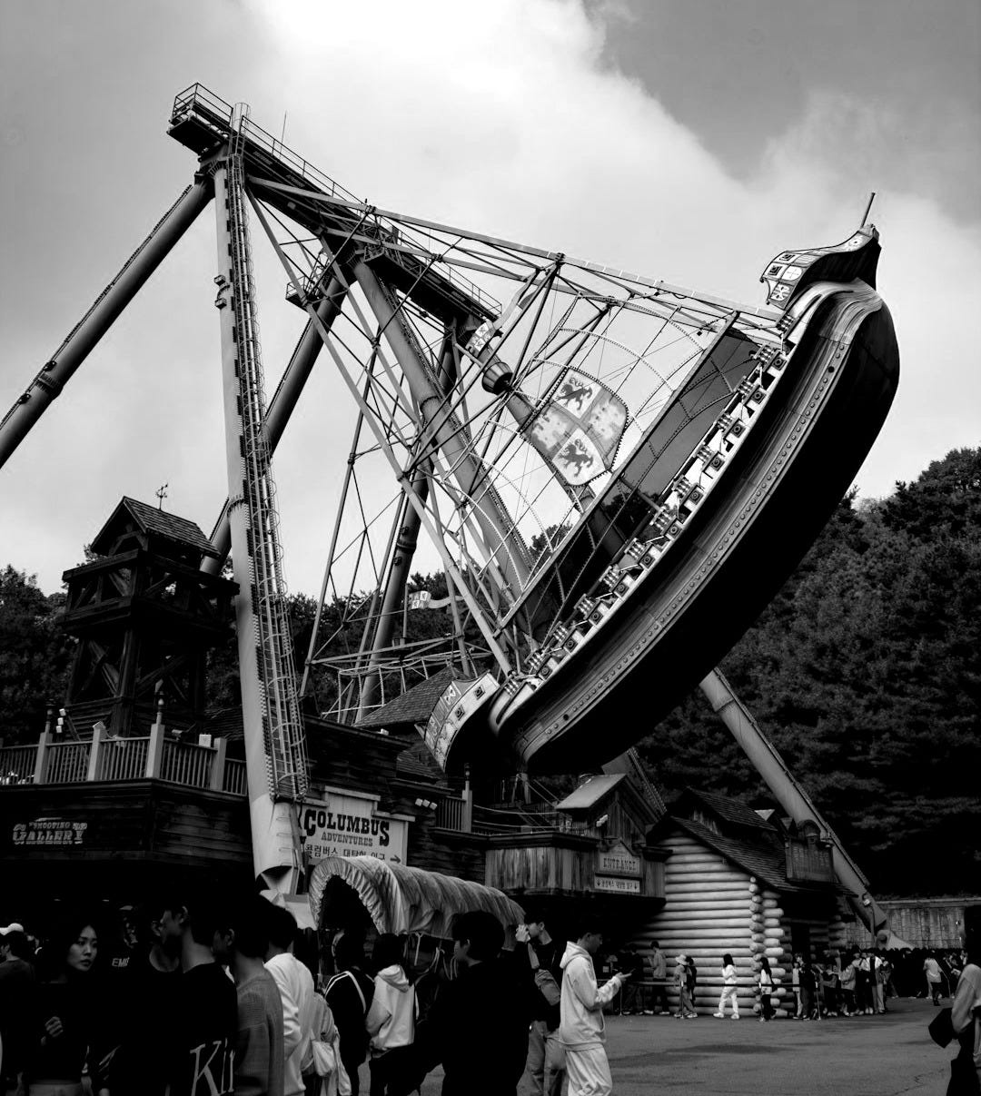 a group of people standing around a large boat a group of people standing around a large boat