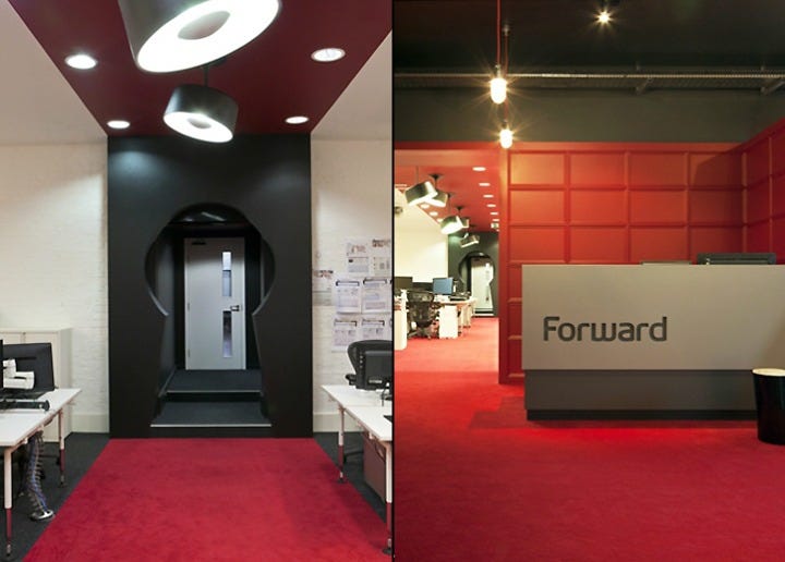 The Forward office in Camden showing the large circular keyhole door inspired by Alice in Wonderland on the left, and the reception area with red carpet and Forward branding on the right—the "opulent confirmation bias" where colleagues confronted the unsustainable developer anarchy. The Forward office in Camden showing the large circular keyhole door inspired by Alice in Wonderland on the left, and the reception area with red carpet and Forward branding on the right—the "opulent confirmation bias" where colleagues confronted the unsustainable developer anarchy.