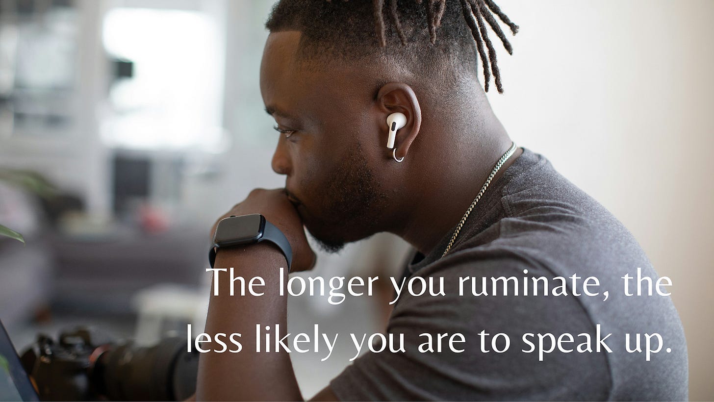 A writer with dreadlocks mulls over his work, he's wearing a Tshirt, airpods and a digital watch.