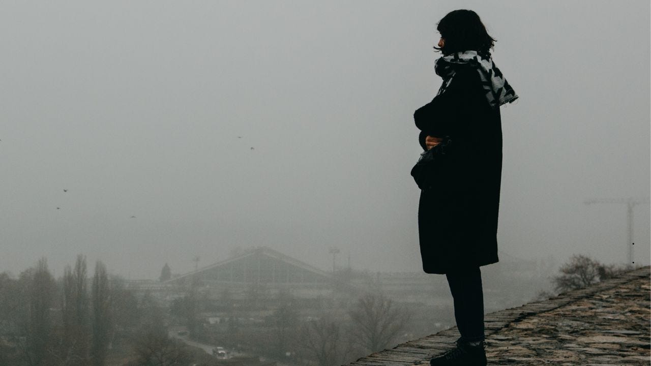 a woman standing alone on a street