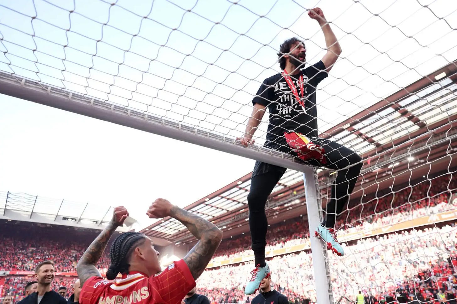 Alisson Becker climbs the crossbar in wild title celebrations at Anfield —  Tribuna.com
