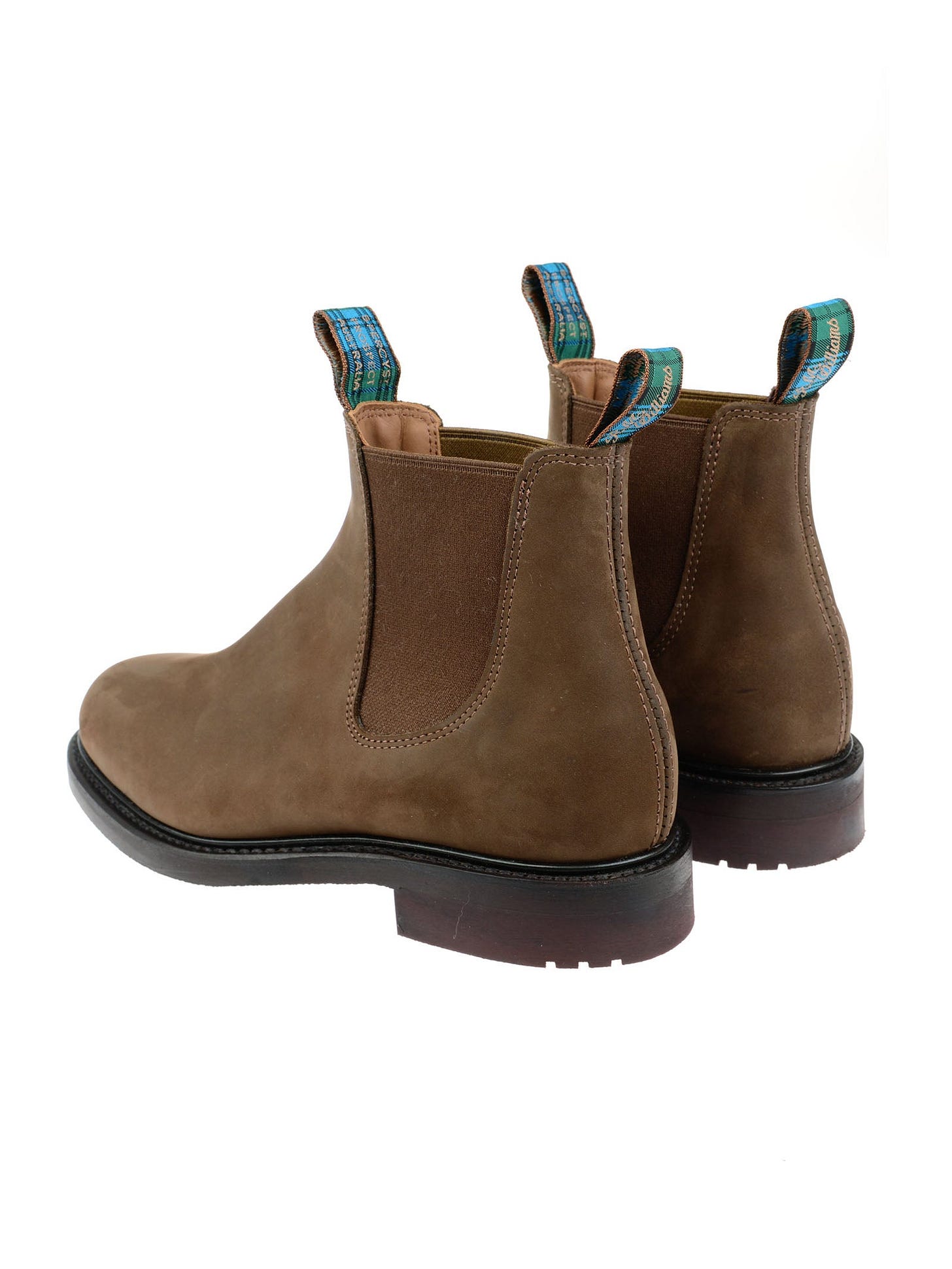 The Men's R.M.Williams Highlander Boot by R.M.Williams x Campbell's of Beauly features brown premium leather, elastic side panels, dark soles, and blue pull tabs, displayed from a rear side angle on a white background. The Men's R.M.Williams Highlander Boot by R.M.Williams x Campbell's of Beauly features brown premium leather, elastic side panels, dark soles, and blue pull tabs, displayed from a rear side angle on a white background.