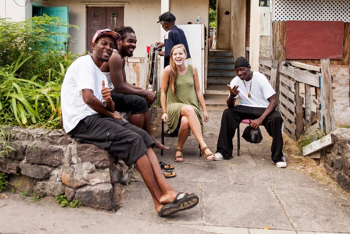 Girl talking with people outside their house