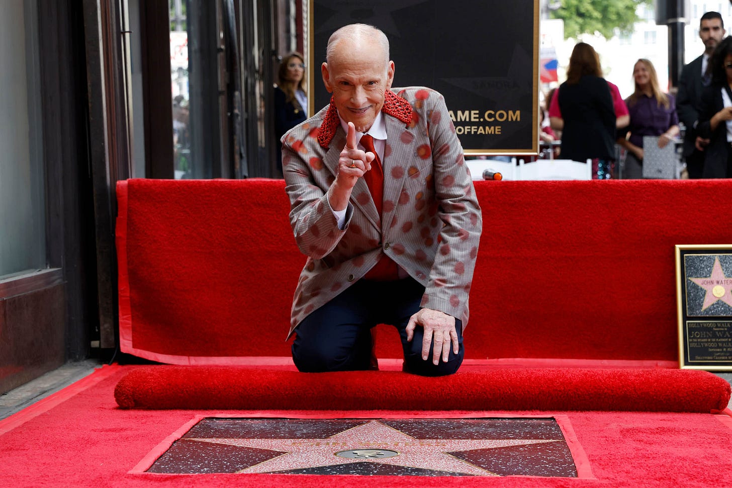 John Waters kneels on top of his newly unveiled Hollywood Walk of Fame star John Waters kneels on top of his newly unveiled Hollywood Walk of Fame star