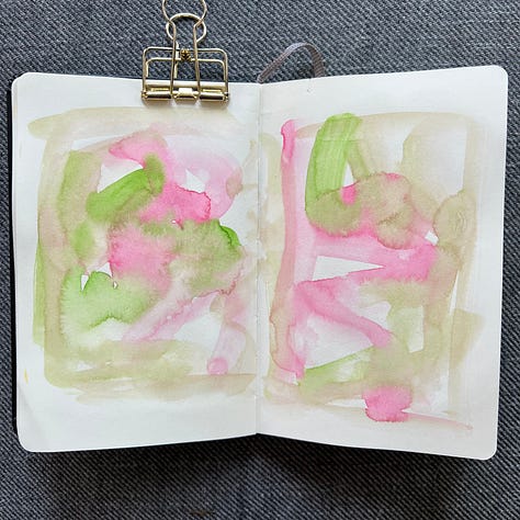 Different pages in a small sketchbook painted with light washes of watercolor in a variety colors