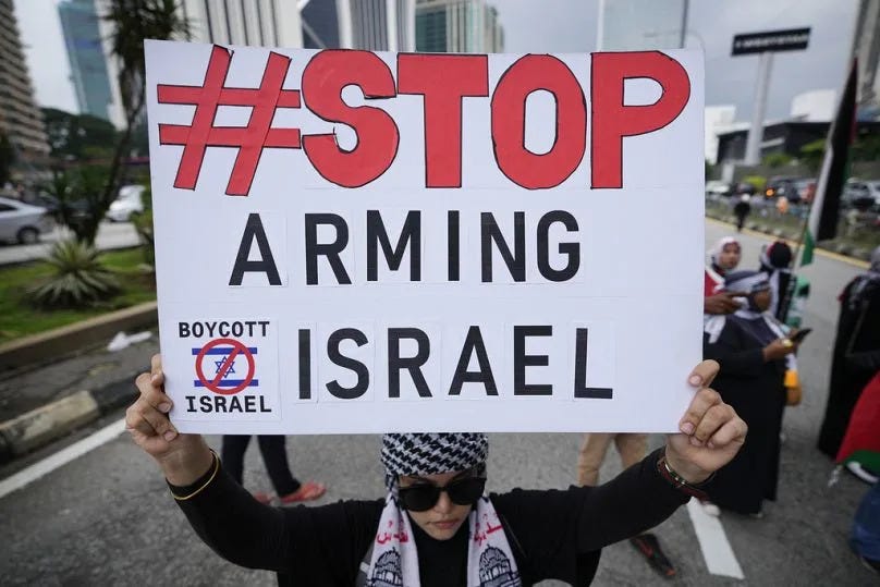 A Malaysian holds a placard during a rally to show their support for Palestinian people in Kuala Lumpur, October 2023
