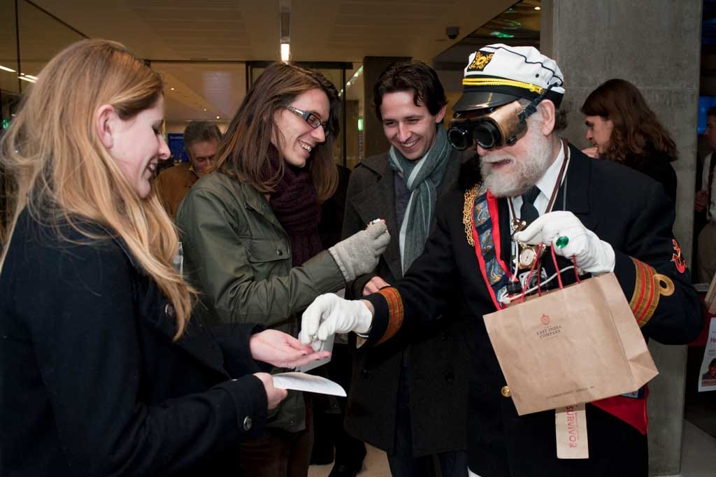 Neil Hornick as Captain Ironside hands out opium wraps in silver foil from an East India Company bag at The Steampunk Opium Wars premiere, Royal National Maritime Museum, 2012. 