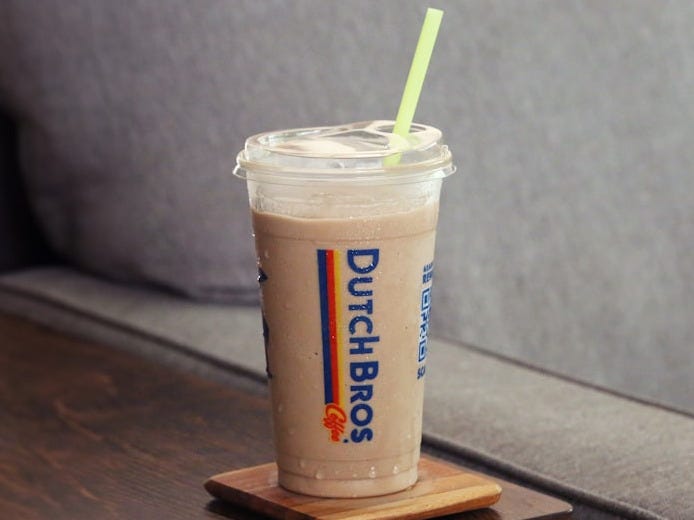 a drink sitting on top of a wooden table