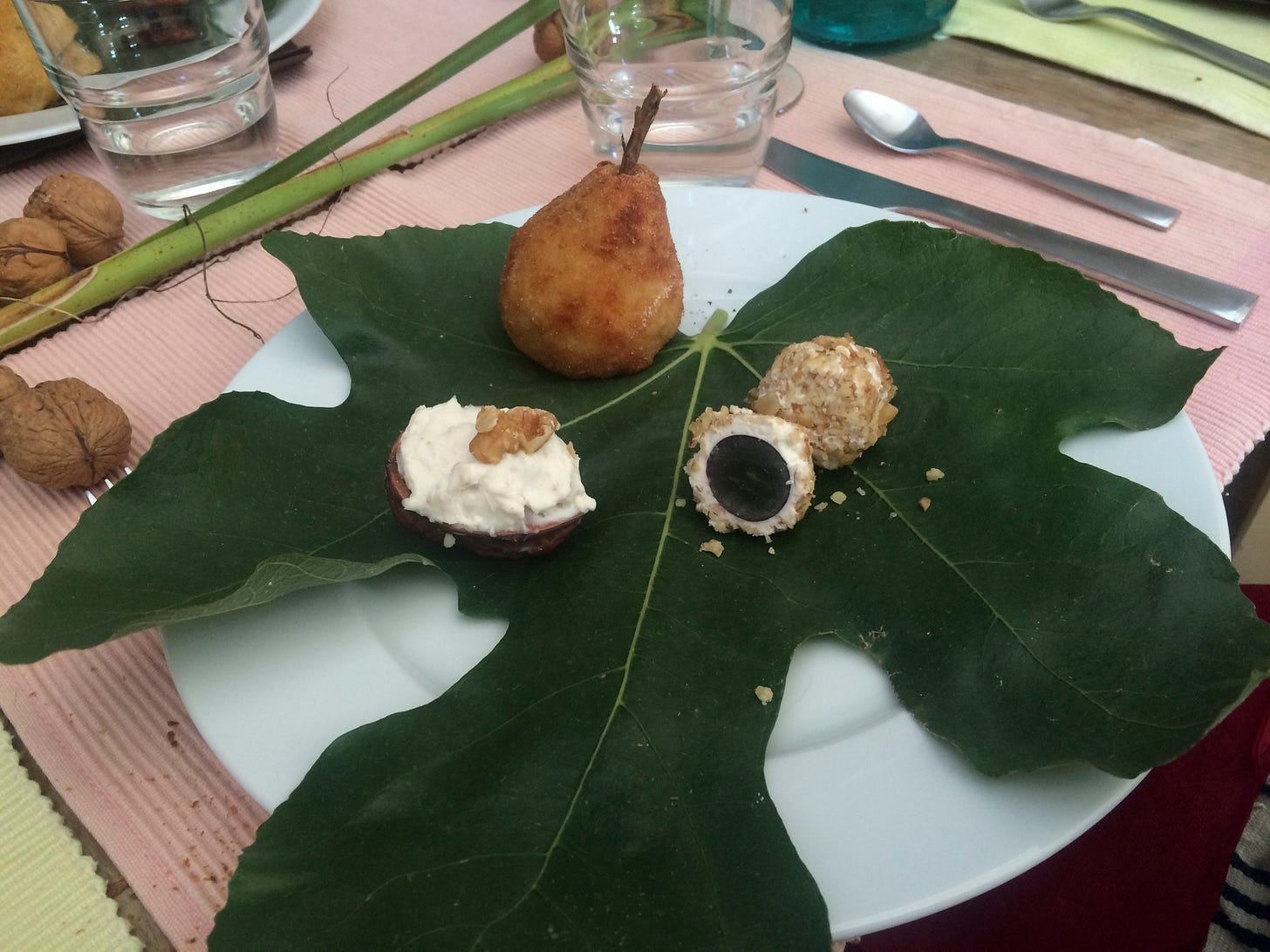 Creamy cheese in a half a walnut shell, grapes covered in cheese then rolled in nuts and a ball of crumbed risotto disguised as a pear.