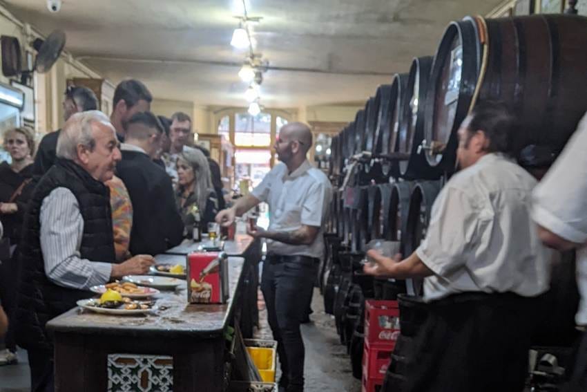 A group of people in a room with barrels

AI-generated content may be incorrect.
