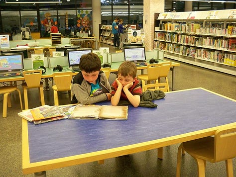 children holding books, reading books, and attending a presentation during a variety of public summer reading programs