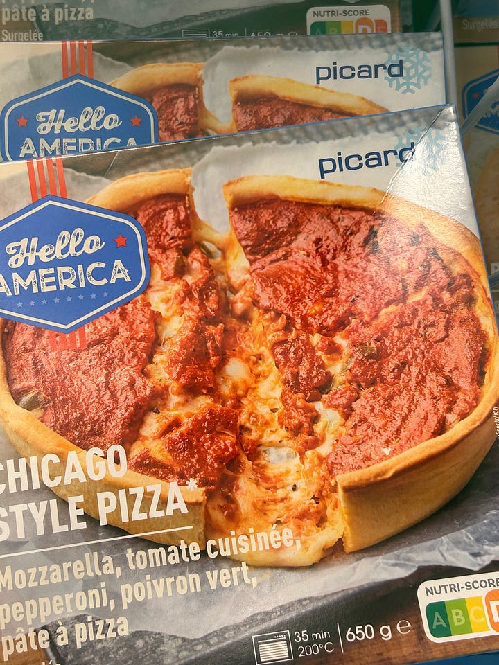 Shopping for frozen food in France. A billboard advertises Hey USA American foods in France, plus frozen food products on shelves in French grocery store