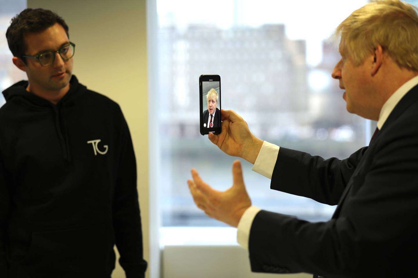 Topham watches as former UK Prime Minister Boris Johnson takes a selfie during the Conservatives' 2019 general election campaign. Topham watches as former UK Prime Minister Boris Johnson takes a selfie during the Conservatives' 2019 general election campaign.