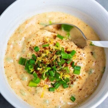 remoulade crab cake sauce topped with scallions in a white bowl