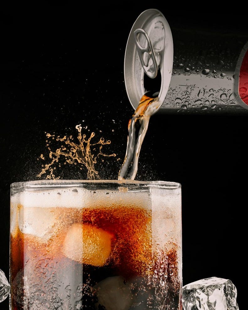 clear drinking glass with brown liquid