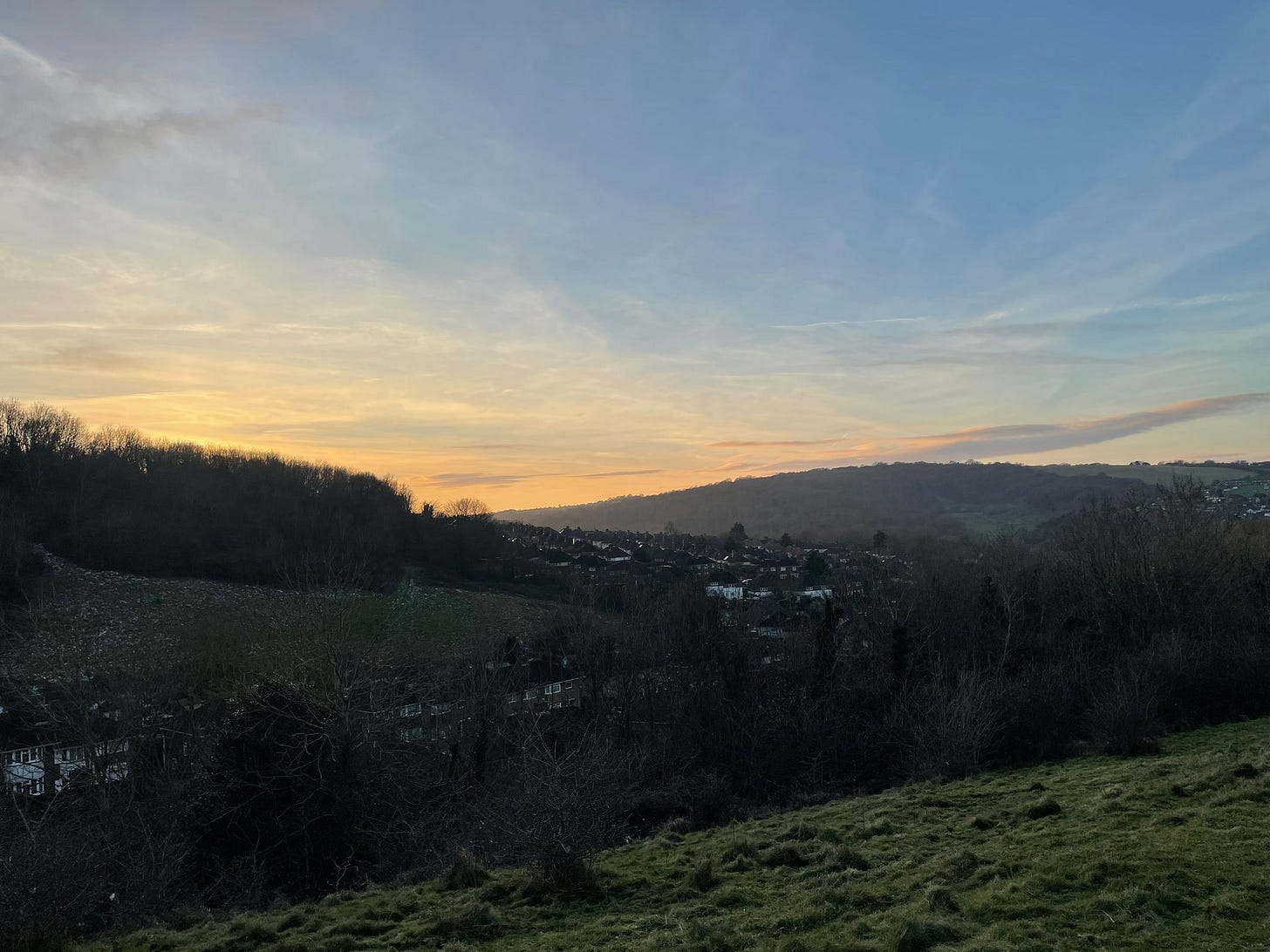 Sunset view of houses nestled in hills