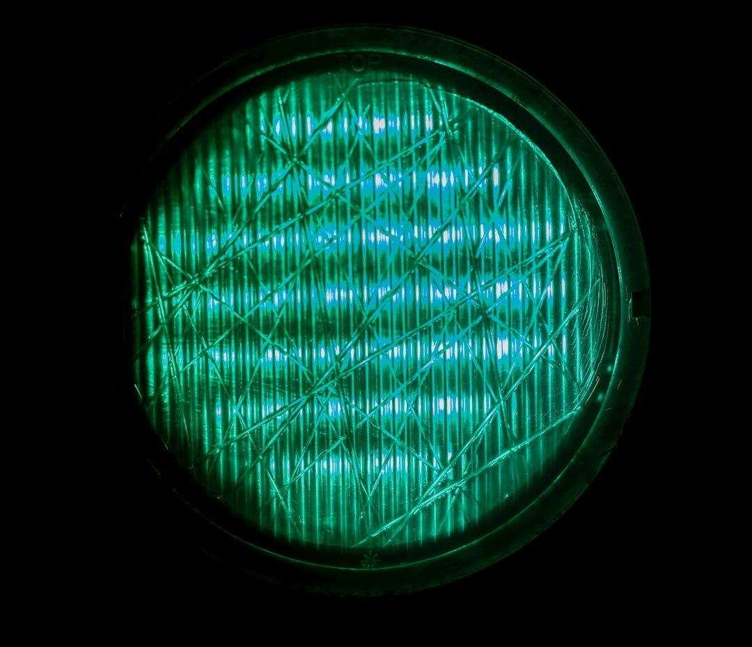 A close up of a green light in the dark