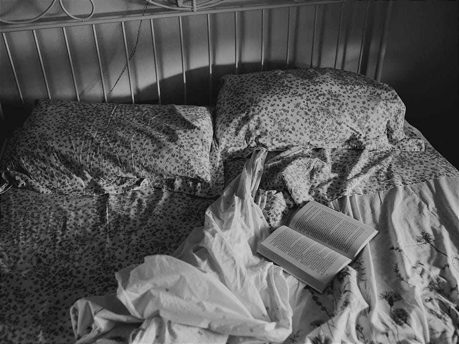 a book is laying on a messy bed a book is laying on a messy bed