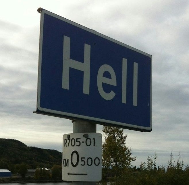 a blue street sign sitting on the side of a road
