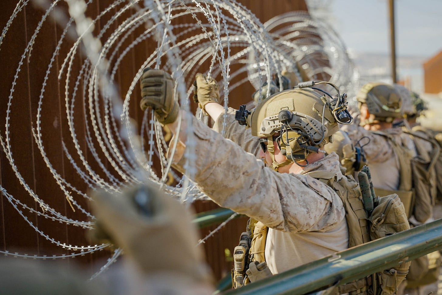 U.S. soldiers are installing coils of concertina wire along the Border Wall in Southern California to make it more difficult to climb.