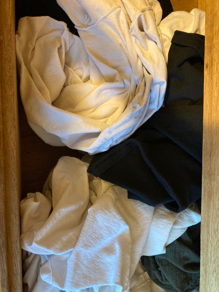 A picture containing indoor, clothes, clothing, messy

Description automatically generated