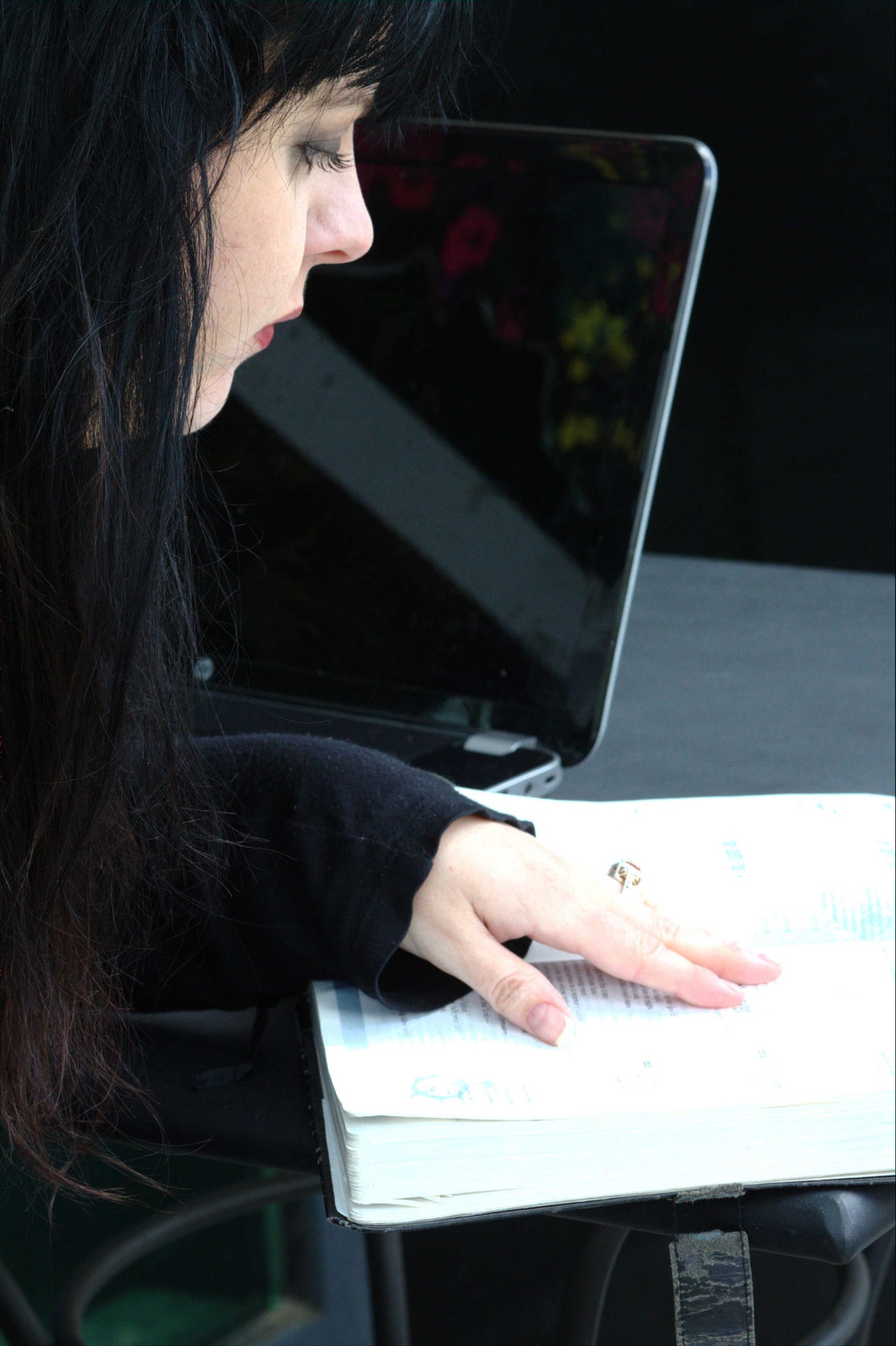 Woman with black hair studies the bible