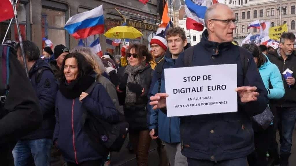 A group of people holding a sign

Description automatically generated