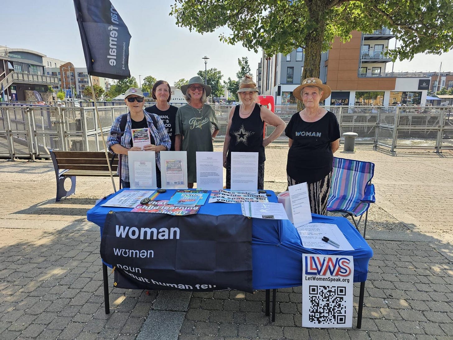 The image shows Action Shot Community Members Engaging Information Table Marina Setting Natural Daylight Warm Tones Documentary Style The image shows Action Shot Community Members Engaging Information Table Marina Setting Natural Daylight Warm Tones Documentary Style