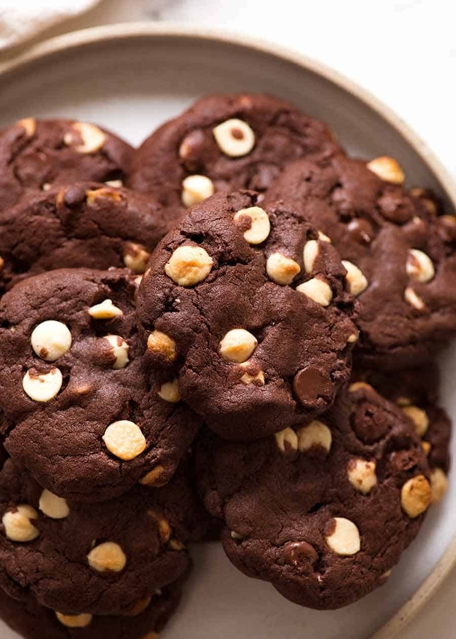 Pile of Triple Chocolate Cookies on a plate, ready to be eaten. Chewy on the inside, 40% chocolate, with crispy edges. Pile of Triple Chocolate Cookies on a plate, ready to be eaten. Chewy on the inside, 40% chocolate, with crispy edges.