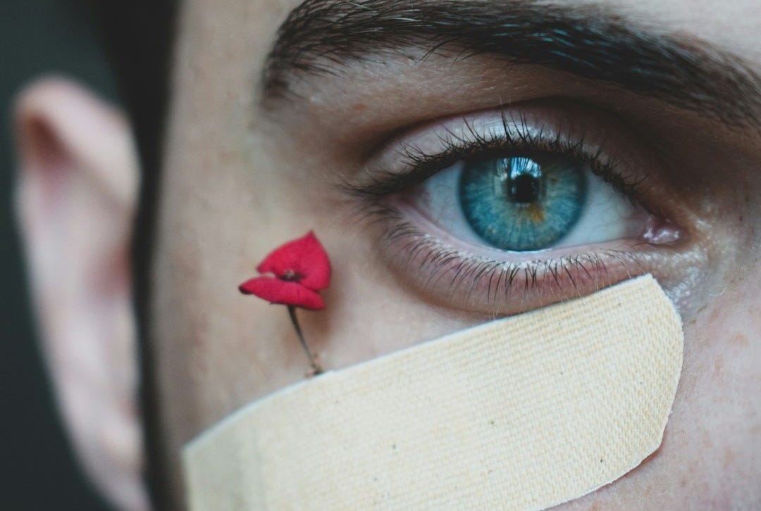person with red and blue eye shadow