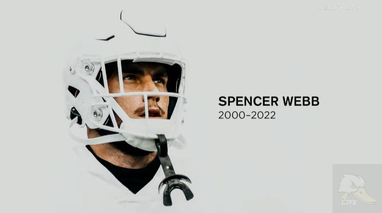 Memorial tribute image of Oregon Ducks football player Spencer Webb (2000–2022), wearing a white helmet and uniform. Celebrate the legacy of Spencer Webb and honor past and present Ducks athletes with Oregon Ducks FansEdge.